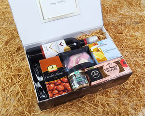 Open Giftbox with food inside sitting on straw