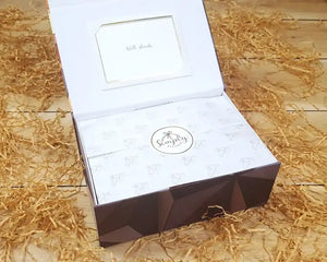 Open gift box with neatly wrapped tissue paper