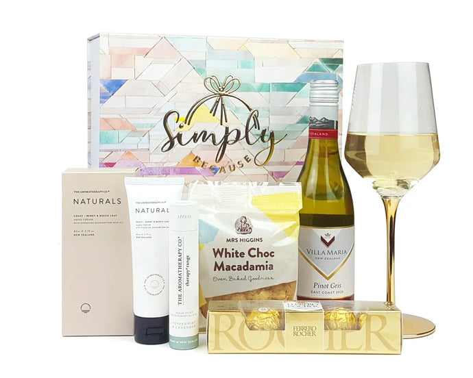 Giftbox with pamper products and wine in front