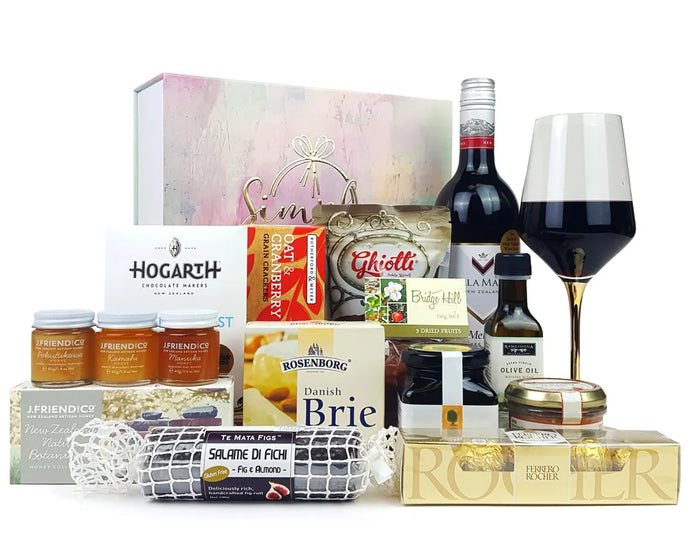 Giftbox with packaged food and wine in front