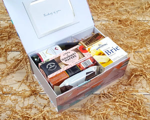 Open gift box with New Zealand treats and wine inside